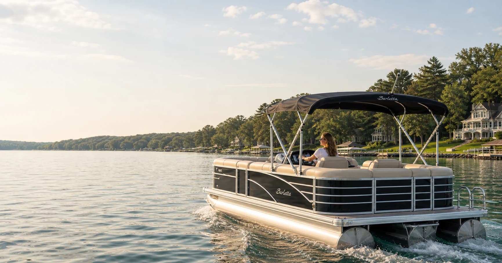 Female captain at the helm of the Barletta pontoon on Geneva Lake