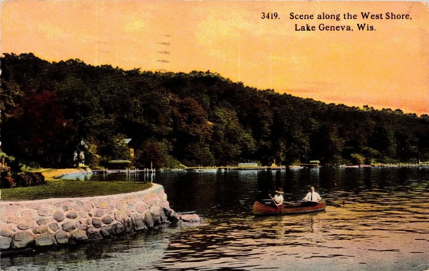 A historic postcard showing Geneva Lake’s wooded western shoreline around 1910