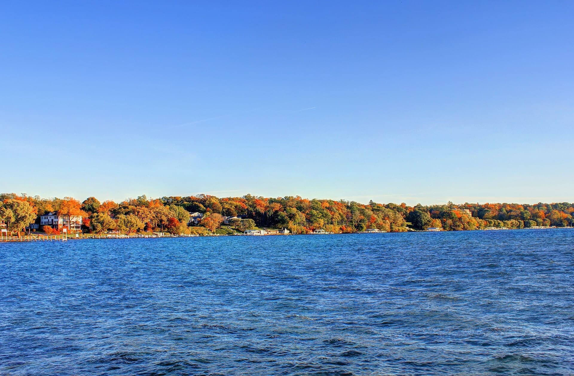 Geneva Lake and its colorful wooded shoreline in autumn