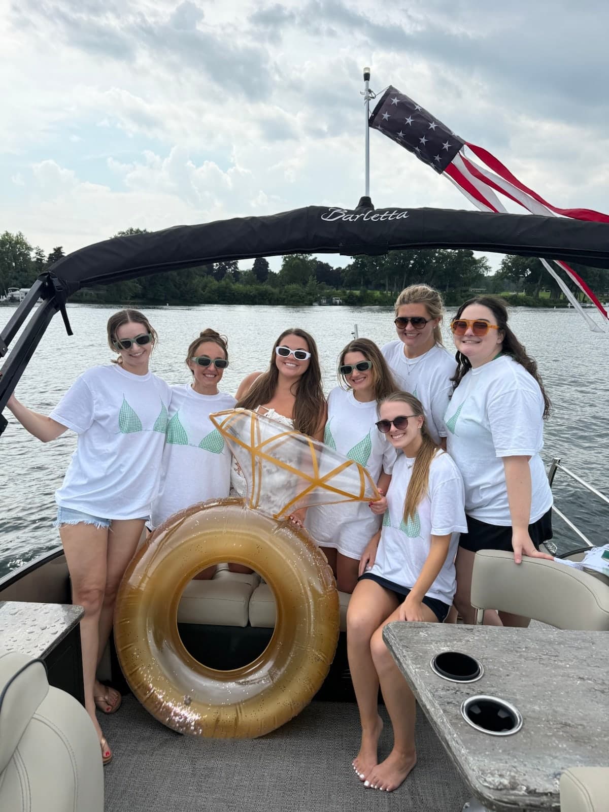 A group of friends celebrating together aboard the Barletta pontoon